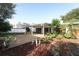 View of the home's backyard with a large patio area with tropical landscaping at 4141 Fallwood Cir, Orlando, FL 32812