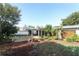 A spacious backyard featuring a large covered patio and lush tropical landscaping at 4141 Fallwood Cir, Orlando, FL 32812