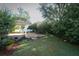 A spacious backyard featuring a large covered patio and a well-manicured lawn at 4141 Fallwood Cir, Orlando, FL 32812