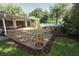 A spacious backyard featuring a large covered patio and well-kept lawn at 4141 Fallwood Cir, Orlando, FL 32812
