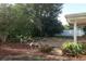 Spacious backyard featuring a large patio area and manicured mulch beds at 4141 Fallwood Cir, Orlando, FL 32812