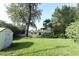 A huge backyard with lush lawn, storage shed and lots of mature trees at 4141 Fallwood Cir, Orlando, FL 32812