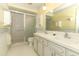 Well-lit bathroom features a double sink vanity and walk-in shower at 4141 Fallwood Cir, Orlando, FL 32812