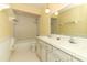 Bathroom with double sink vanity, large mirror, and shower-tub combo at 4141 Fallwood Cir, Orlando, FL 32812