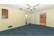 Bright bedroom features blue carpet, yellow striped walls, and ceiling fan at 4141 Fallwood Cir, Orlando, FL 32812