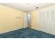 Bright bedroom featuring a closet, blue carpet, yellow walls, and decorative border at 4141 Fallwood Cir, Orlando, FL 32812