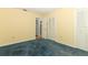 Bedroom featuring yellow walls, blue carpet and built in closet at 4141 Fallwood Cir, Orlando, FL 32812