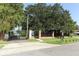 An image of the community gate with surrounding mature trees and well maintained landscaping at 4141 Fallwood Cir, Orlando, FL 32812