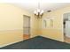 Open dining area with classic chandelier and views into adjacent rooms at 4141 Fallwood Cir, Orlando, FL 32812