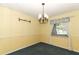 Sunny dining room with traditional chandelier and bright yellow walls at 4141 Fallwood Cir, Orlando, FL 32812