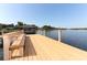 Dock view with bench looking out to calm lake and covered boat slip at 4141 Fallwood Cir, Orlando, FL 32812