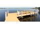 Picturesque wooden dock on a tranquil lake with clear water at 4141 Fallwood Cir, Orlando, FL 32812
