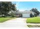 Charming single-story home with a well-manicured lawn and attached two-car garage at 4141 Fallwood Cir, Orlando, FL 32812