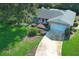 Attractive single-story home features a well-maintained lawn, lush landscaping, and an attached two-car garage at 4141 Fallwood Cir, Orlando, FL 32812