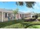 A charming brick home with a bright red front door and beautifully landscaped front yard at 4141 Fallwood Cir, Orlando, FL 32812