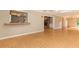 Open living room features a bar pass-through to the kitchen, and hardwood floors at 4141 Fallwood Cir, Orlando, FL 32812