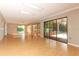 Large living room featuring skylights, sliding glass doors, and hardwood floors at 4141 Fallwood Cir, Orlando, FL 32812