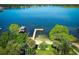 Picturesque waterfront view with a private dock, boat house, and lush green surroundings at 4141 Fallwood Cir, Orlando, FL 32812