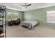 A bright bedroom with a tray ceiling, large window, and comfortable carpeting at 4751 Aguila Pl, Orlando, FL 32826