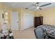 Bedroom featuring a ceiling fan, a large closet, and neutral carpet at 4751 Aguila Pl, Orlando, FL 32826