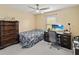 Bedroom featuring a ceiling fan, a large dresser, and desk space at 4751 Aguila Pl, Orlando, FL 32826