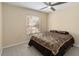 Bedroom featuring a ceiling fan, natural light, and neutral carpet at 4751 Aguila Pl, Orlando, FL 32826