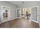 Bonus room featuring glass doors, luxury vinyl plank flooring, and a ping pong table at 4751 Aguila Pl, Orlando, FL 32826