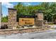 Rybolt's Reserve entrance with stone pillars and lush landscaping provides a welcoming feel at 4751 Aguila Pl, Orlando, FL 32826
