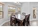 A bright dining area with a large table and views of the yard at 4751 Aguila Pl, Orlando, FL 32826