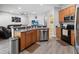 The kitchen offers a breakfast bar and stainless steel appliances at 4751 Aguila Pl, Orlando, FL 32826