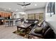 A spacious living room features a comfortable leather sofa, stylish rug, and plenty of natural light at 4751 Aguila Pl, Orlando, FL 32826