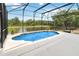 Screened pool with a beautiful water view, fountains, and a spacious patio area at 4751 Aguila Pl, Orlando, FL 32826