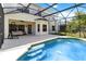 Outdoor screened-in pool with a tanning ledge and a covered patio with a swing, ideal for relaxation and entertainment at 4751 Aguila Pl, Orlando, FL 32826