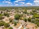 Wide aerial view of neighborhood showcasing tree-lined streets and nearby lake at 514 Richmond Ave, Deltona, FL 32725