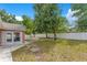 Fenced backyard with trees, grass and patio at 514 Richmond Ave, Deltona, FL 32725