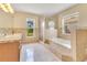 Primary bathroom with tub, glass enclosed shower, double sink vanity, and tile flooring at 514 Richmond Ave, Deltona, FL 32725