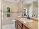 Well-lit bathroom features a vanity with a sink, a toilet, and neutral tile at 514 Richmond Ave, Deltona, FL 32725
