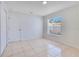 Bedroom with tile flooring, closet, and a window with backyard view, offering great light at 514 Richmond Ave, Deltona, FL 32725