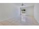 Bright bedroom featuring tile flooring and a window view to the backyard at 514 Richmond Ave, Deltona, FL 32725