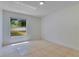 Bedroom with tile flooring and window, offering plenty of natural light and backyard views at 514 Richmond Ave, Deltona, FL 32725