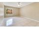 Bedroom with tile flooring, neutral walls, ceiling fan, and window with view at 514 Richmond Ave, Deltona, FL 32725