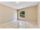 Inviting bedroom with neutral-toned walls, complemented by sleek tile flooring and a bright window at 514 Richmond Ave, Deltona, FL 32725