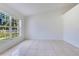 Bright room showcasing tiled flooring, a vaulted ceiling, and ample natural light at 514 Richmond Ave, Deltona, FL 32725