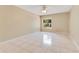 Bedroom featuring tile flooring, ceiling fan, neutral walls and a backyard view at 514 Richmond Ave, Deltona, FL 32725