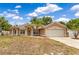 Charming single-story home with a two-car garage, lush landscaping, and a well-manicured lawn at 514 Richmond Ave, Deltona, FL 32725