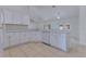 Bright kitchen featuring white cabinets, tile floor, and stainless steel appliances at 514 Richmond Ave, Deltona, FL 32725