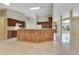 Open kitchen featuring an island with wood paneling, tile floors, and dark wood cabinets at 514 Richmond Ave, Deltona, FL 32725
