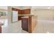 Open-concept kitchen with island, dark cabinetry, tile flooring, connecting to the living area at 514 Richmond Ave, Deltona, FL 32725