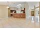 Spacious kitchen with wooden island, tile floors, and views to the front door at 514 Richmond Ave, Deltona, FL 32725