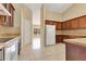 Bright kitchen with tile flooring, dark wood cabinets, and modern appliances, offering ample storage at 514 Richmond Ave, Deltona, FL 32725